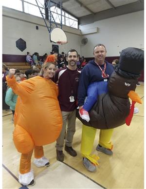 Three physical education and health teachers dressed for the turkey trot 